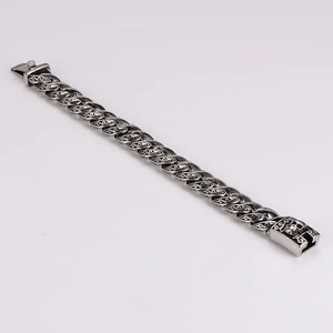 Close-up of vintage steel chain bracelet with intricate tribal vine pattern engraving