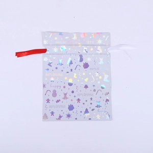 Detail of silver holographic drawstring bag with Merry Christmas pattern and festive print