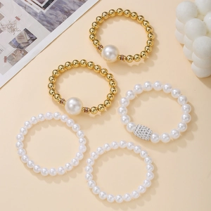 Five-piece stacked pearl bracelet set with large beads and crystal-encrusted accents