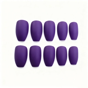 Detail view of ten matte dark purple press-on nails in various sizes on a white background