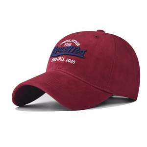 Detail of burgundy baseball cap with 3D embroidery Dreams and premium metal eyelets