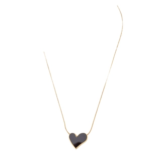Elegant gold titanium necklace with a minimalist black heart pendant on a white background