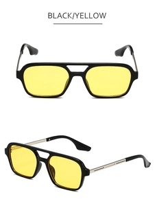 Detail of vintage double bridge sunglasses with black frames and yellow lenses