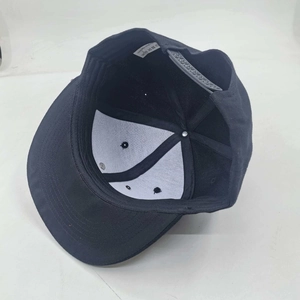 Detail view of black hip-hop cap interior featuring polyester lining and snapback closure