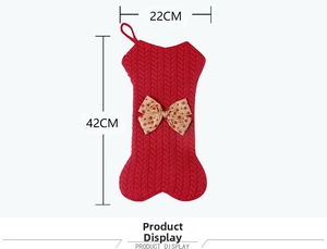 Macro detail of bone-shaped red knit Christmas stocking with a polka dot bow and 42cm height