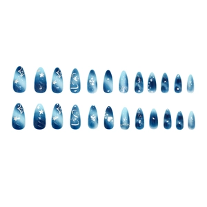 Star and moon themed cat eye press-on nails in blue gradient with glitter accents