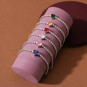 Luxurious heart zircon tennis bracelets in multiple colors on a purple display stand
