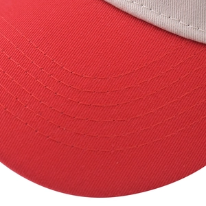 Detailed close-up of red cotton twill brim with reinforced parallel stitching on baseball cap