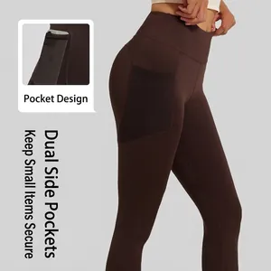 High waist dark brown yoga pants featuring lateral black mesh pockets and lifting effect
