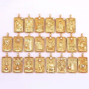 Set of 22 gold tarot card pendants with cubic zirconia inlay on white background