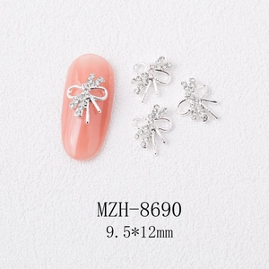 Macro shot of silver 3D bow nail charms with rhinestones, size 9.5x12mm, item MZH-8690