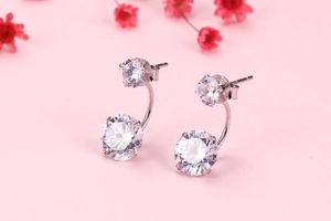 Detail view of S925 silver double zircon earrings with a curved hanging drop design