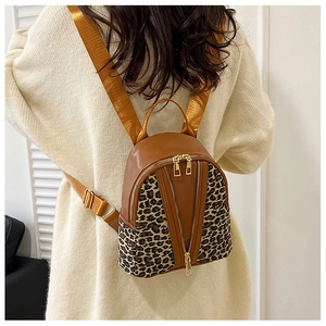 Brown leather and leopard print backpack featuring V-shaped double zippers on the back