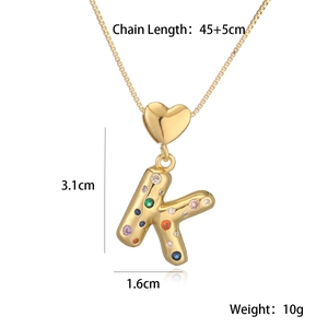 Detail showing letter K gold pendant with colorful gems and size specifications