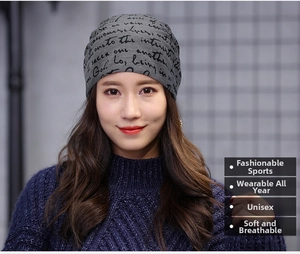 Grey beanie with black cursive print showing soft knitted texture and snug fit on model