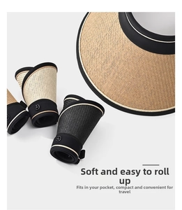 Foldable straw sun visor with black trim showing compact roll-up storage design