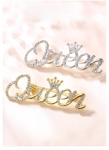 Detailed close-up of Queen letter brooches with crowns in gold and silver finish