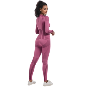 Detail of seamless compression knit zones on high-waist leggings and long sleeve top