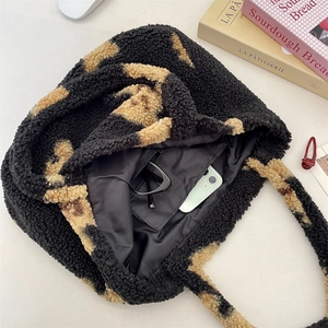 Interior detail of leopard print plush tote with inner zipper pocket and storage capacity