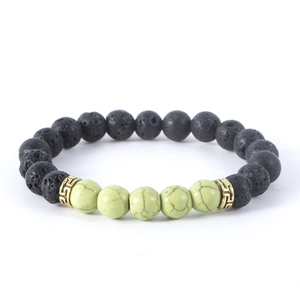 Natural lava rock and green stone beaded bracelet with stylish gold tone spacer charms.