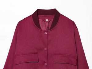 Detailed close-up of burgundy jacket showing snap buttons and flap pockets