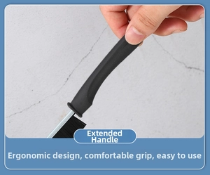 Detail of ergonomic long handle on a black stiff bristle gap brush for narrow tile cleaning