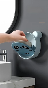 Detail of wall-mounted panda soap dish showing easy flip lid and drainage function