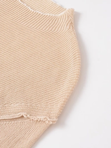 Detailed view of the fine knit texture and white piped edges of this apricot knit top