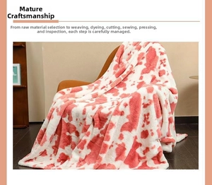 Close-up of pink cow print flannel blanket draped on a wooden chair in cozy setting