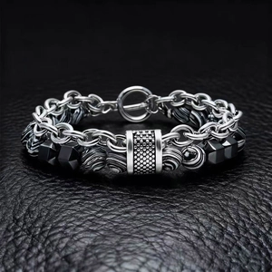 Detail of silver OT clasp and malachite pattern beads on a luxury men's bracelet