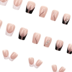 French tip press-on nails set with black lines and rhinestones on nude base