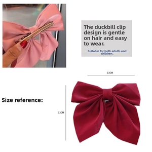 Detailed view of pink and dark red fabric bow hair clips with a 13cm size reference