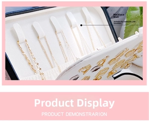 Detail view of double-layer jewelry box interior with necklace hooks and earring slots