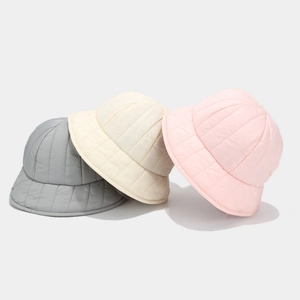 Quilted down puffer bucket hats in grey, beige, and pink with warm padded texture