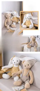 Close-up of plush teddy bear and white rabbit dolls wearing removable patterned pajamas
