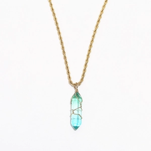 Detail of gold rope chain and gradient crystal pendant with delicate wire wrapping