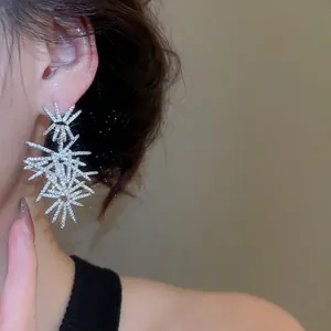 Sparkling silver starburst dangle earrings with premium cubic zirconia for women