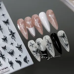 Detailed 5D butterfly nail art decals with black moth and star patterns on long stiletto nails