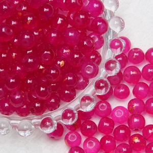 Macro detail of 8mm pink frosted glass beads with gold glitter for DIY jewelry making