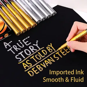 Gold and silver metallic craft markers on black paper for DIY art and calligraphy