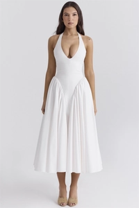 Macro view of pleated waist detail on a white deep V-neck halter midi dress