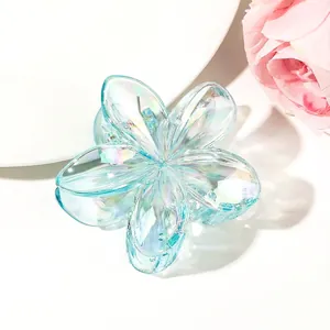 Detail of blue iridescent flower claw clip with gradient multi-color luster finish