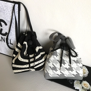 Knitted drawstring bucket bags with zebra and houndstooth patterns and shoulder straps