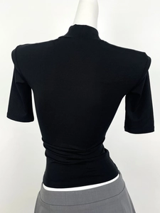 Close-up back view of black ribbed knit t-shirt with half-high collar on mannequin