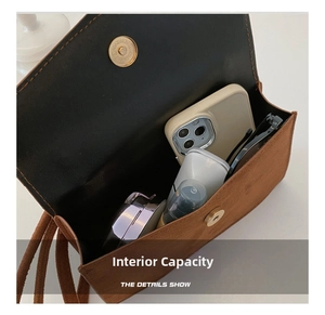 Brown matte suede crossbody bag interior showing phone, makeup, and daily essentials