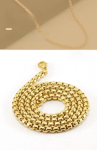 Detail shot of golden stainless steel box chain necklace with high polish and lobster clasp
