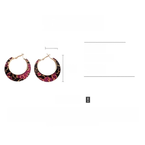 Detail view of large resin hoop earrings with tortoiseshell texture and 4.5cm diameter