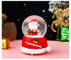 Detail of Christmas crystal ball with Santa figure, resin hat base and warm festive lights