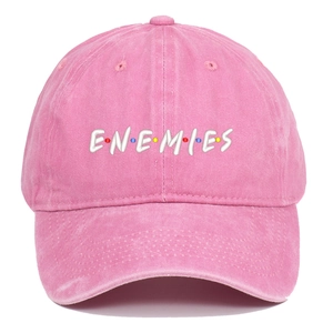 Close-up of pink washed baseball cap with ENEMIES embroidery and colorful dots