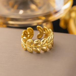 Polished 18K gold olive leaf open ring featuring adjustable design on a dark background